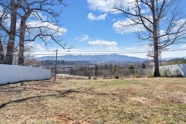 view of yard with a mountain view and fence