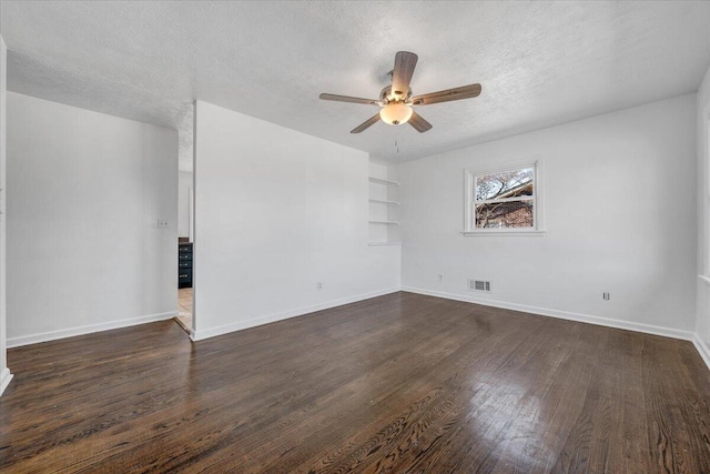 spare room featuring visible vents, baseboards, a textured ceiling, a ceiling fan, and dark wood-style flooring