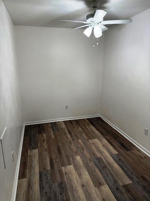 spare room featuring dark wood-style floors, baseboards, and ceiling fan