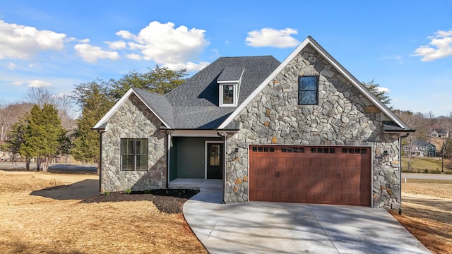 view of front of house with a garage, roof with shingles, and concrete driveway