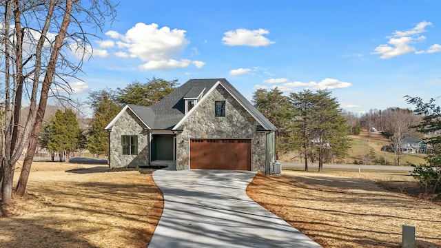 view of front of property with concrete driveway, a garage, and stone siding