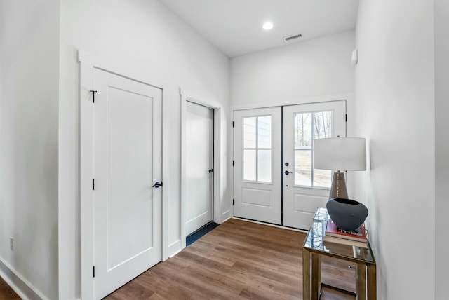 entrance foyer featuring recessed lighting, visible vents, wood finished floors, and french doors