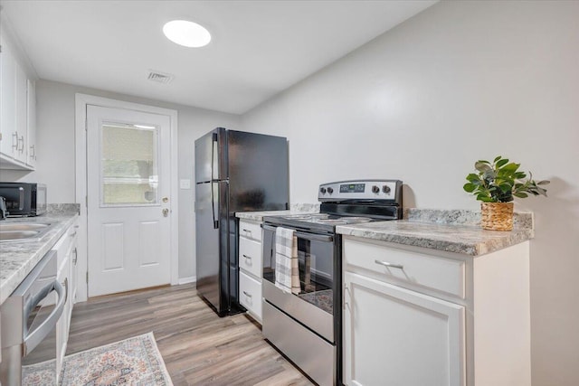 39 Daisy Hill Ln, Rocky Mount, VA 24151 - kitchen featuring black appliances, white cabinets, visible vents, and light wood finished floors