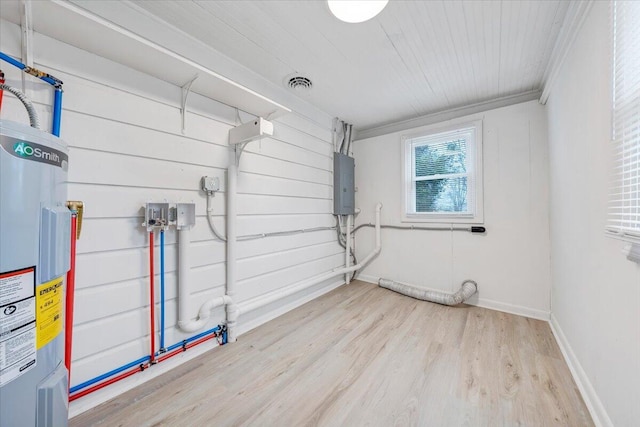 washroom with visible vents, water heater, laundry area, electric panel, and wood finished floors