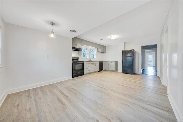 kitchen with visible vents, gray cabinets, black appliances, light countertops, and light wood-style floors