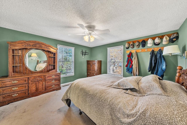 bedroom featuring a textured ceiling, carpet, and ceiling fan