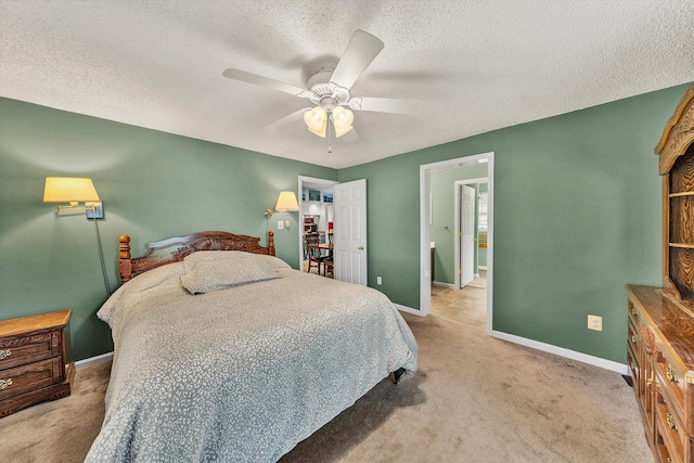 bedroom with baseboards, carpet, and a textured ceiling