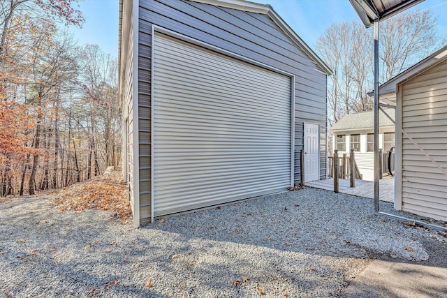 garage with gravel driveway