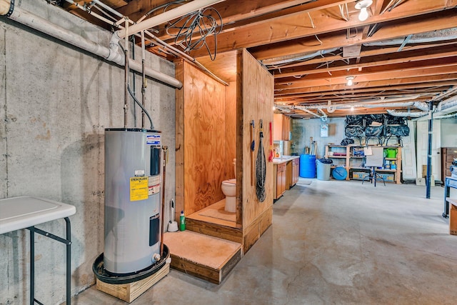 unfinished basement featuring electric water heater