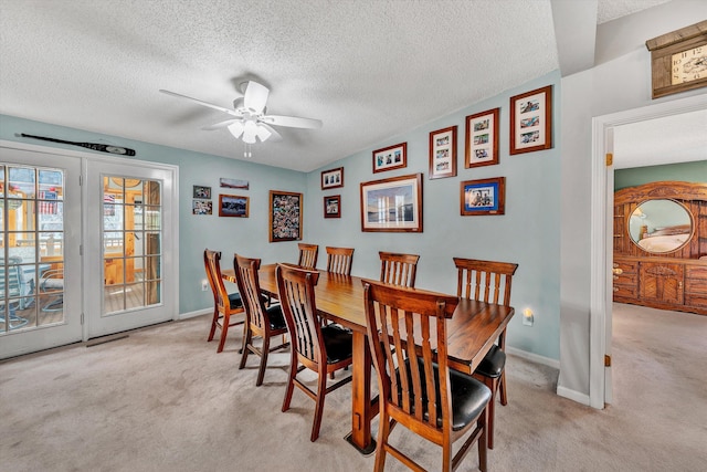 dining space featuring baseboards, carpet, ceiling fan, and a textured ceiling