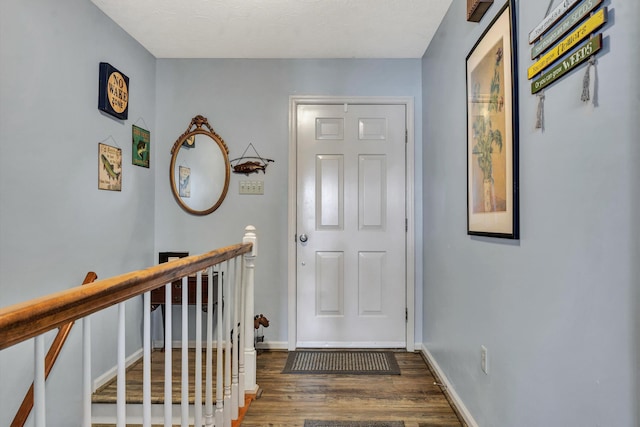 entrance foyer featuring baseboards and wood finished floors