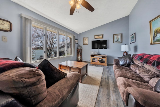 living area featuring lofted ceiling, wood finished floors, and ceiling fan