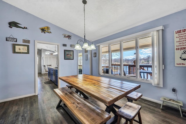 dining space with baseboards, dark wood-type flooring, and lofted ceiling