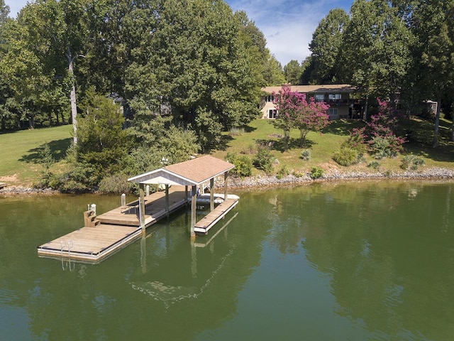 dock area featuring a water view and a lawn