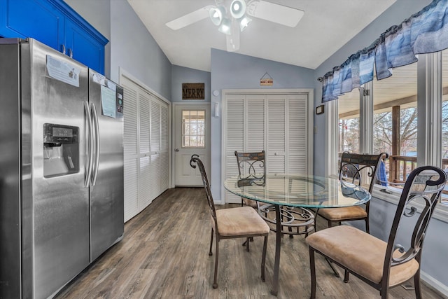 dining room featuring baseboards, dark wood-type flooring, a ceiling fan, and vaulted ceiling