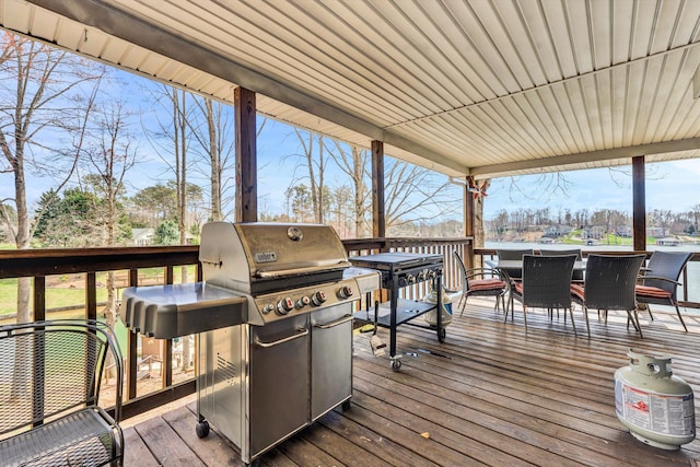 wooden terrace featuring outdoor dining area and area for grilling