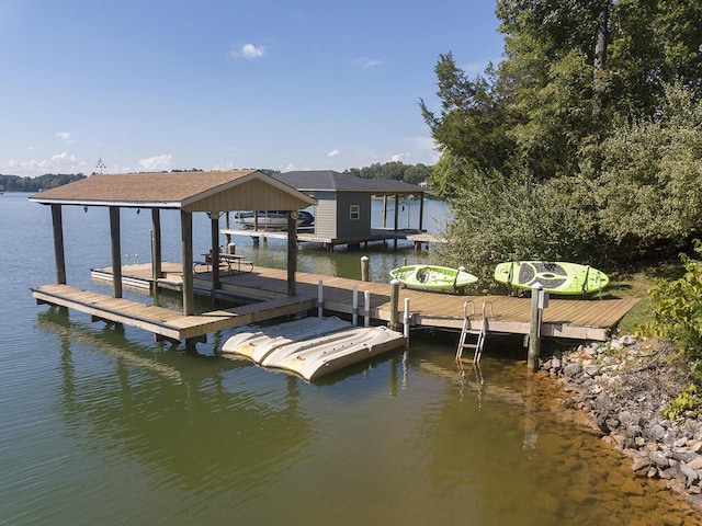 dock area featuring boat lift and a water view