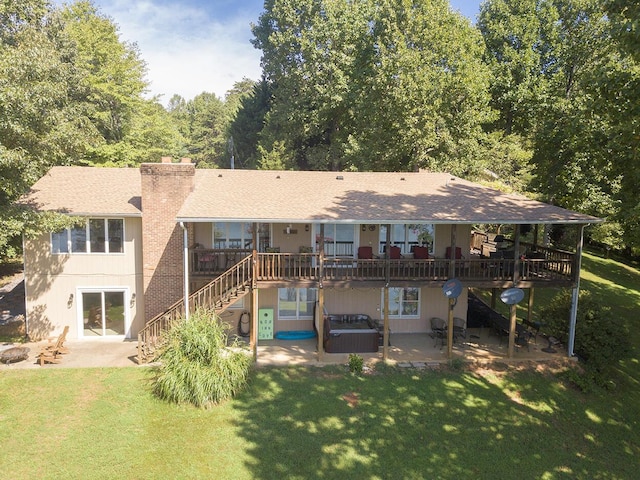 back of property featuring a patio area, a lawn, a chimney, and stairs