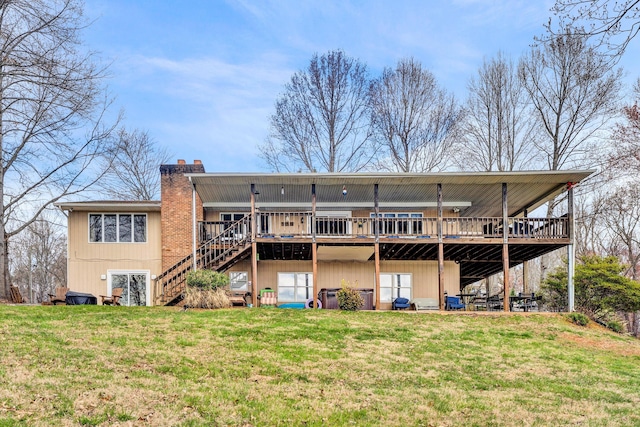 back of property with a wooden deck, stairway, a yard, and a chimney