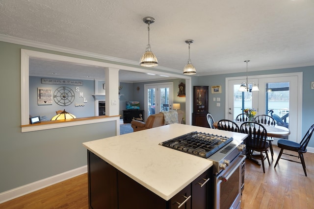 kitchen featuring light countertops, french doors, light wood finished floors, and high end stove