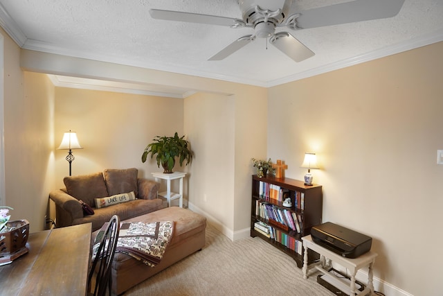 living room with a textured ceiling, carpet, crown molding, baseboards, and ceiling fan