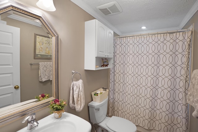 full bathroom featuring visible vents, toilet, ornamental molding, a textured ceiling, and a sink