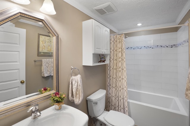 bathroom featuring visible vents, crown molding, toilet, a textured ceiling, and a sink