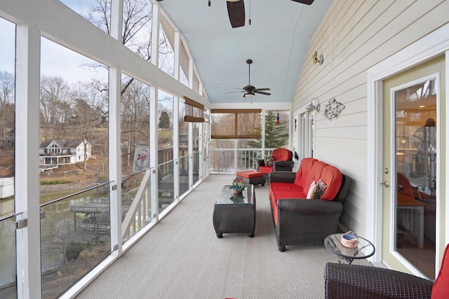 sunroom / solarium with a wealth of natural light, lofted ceiling, and ceiling fan