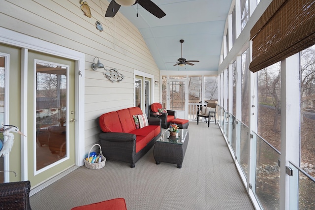 sunroom with a ceiling fan and lofted ceiling