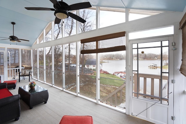 sunroom with a water view, plenty of natural light, lofted ceiling, and ceiling fan