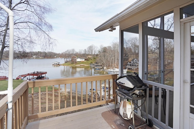 wooden terrace featuring a water view