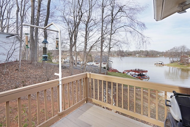 wooden deck featuring a boat dock and a water view