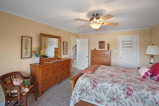 carpeted bedroom with ceiling fan and ornamental molding