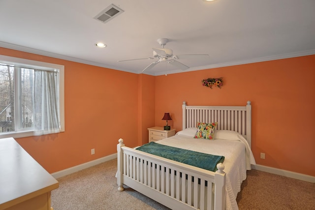 bedroom with light carpet, visible vents, crown molding, and baseboards