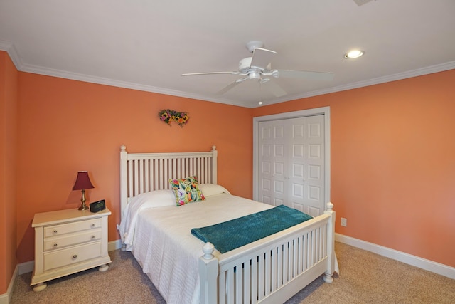 bedroom with light colored carpet, baseboards, a closet, and ornamental molding