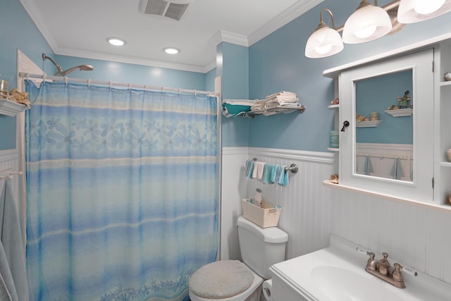 full bathroom with a wainscoted wall, visible vents, ornamental molding, a sink, and a shower with shower curtain