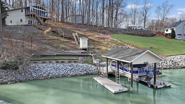 view of dock featuring stairway, a yard, and a water view