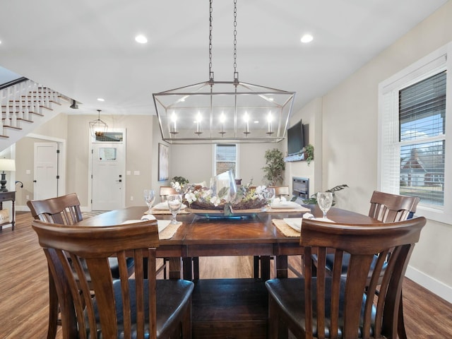 dining space featuring stairway, recessed lighting, baseboards, and wood finished floors