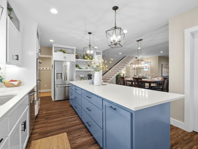 kitchen featuring dark wood finished floors, open shelves, blue cabinets, and appliances with stainless steel finishes