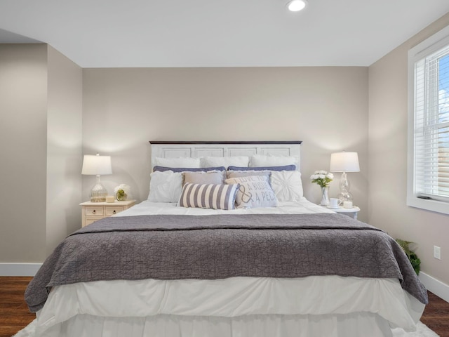 bedroom with recessed lighting, baseboards, and wood finished floors