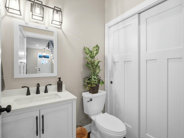 bathroom featuring vanity and toilet