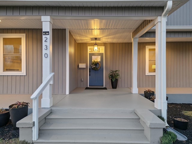 view of exterior entry with a porch