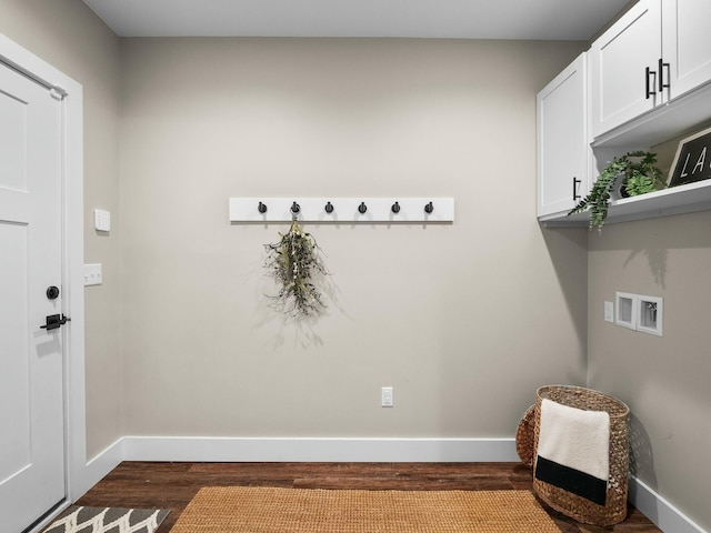 clothes washing area featuring cabinet space, hookup for a washing machine, dark wood-type flooring, and baseboards