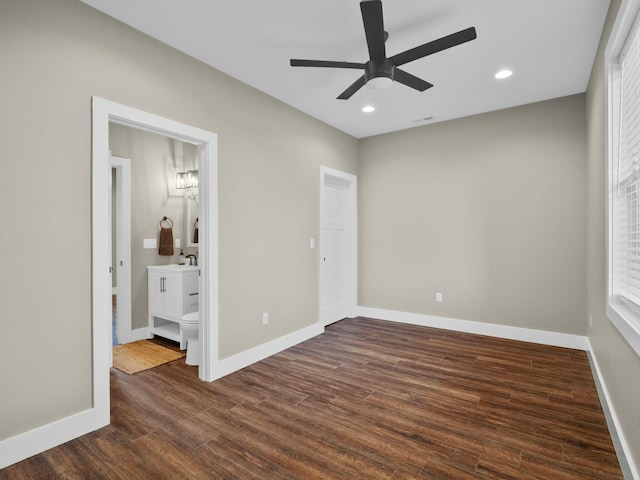 unfurnished bedroom with recessed lighting, dark wood-type flooring, and baseboards