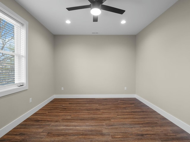 unfurnished room featuring visible vents, recessed lighting, dark wood-style floors, and baseboards