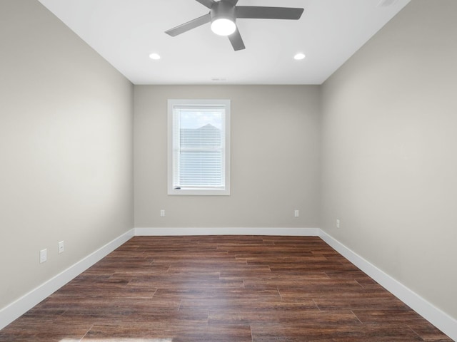 spare room featuring a ceiling fan, recessed lighting, dark wood-style floors, and baseboards