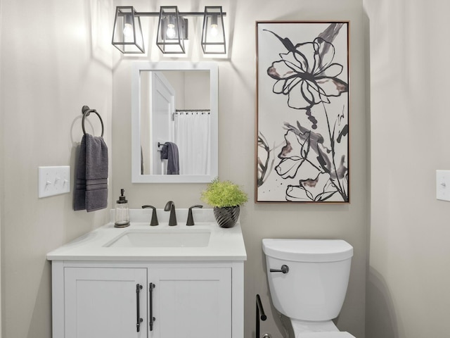 bathroom with toilet and vanity