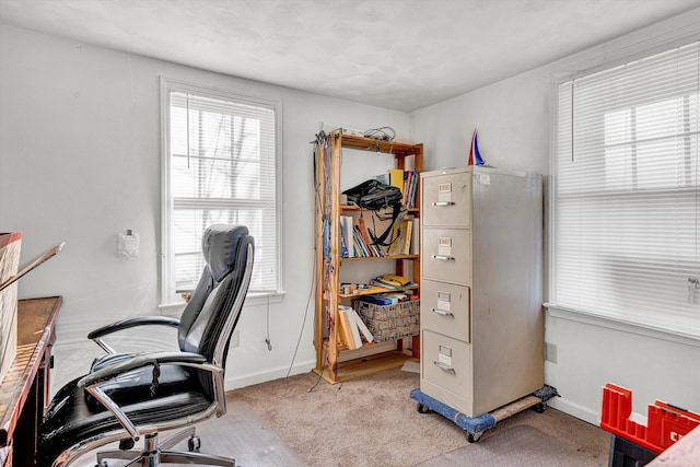 carpeted home office with baseboards