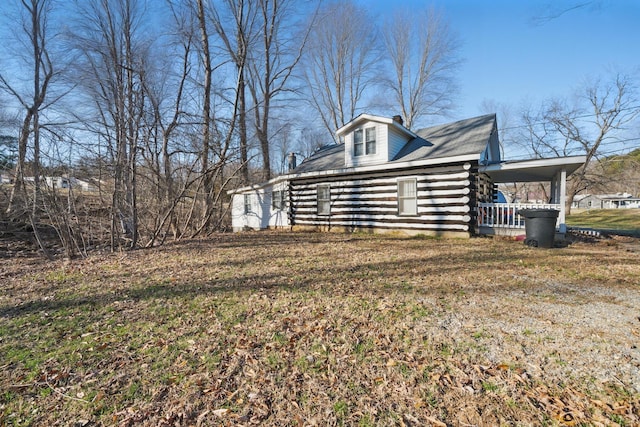 view of property exterior with log siding