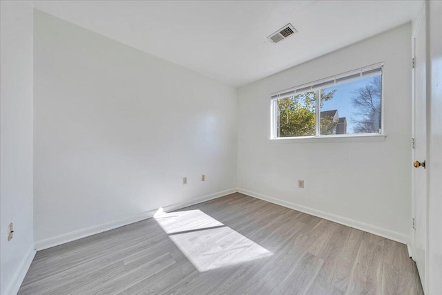 unfurnished room with visible vents, baseboards, and light wood finished floors